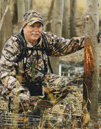 Stan Potts looking at a buck rub